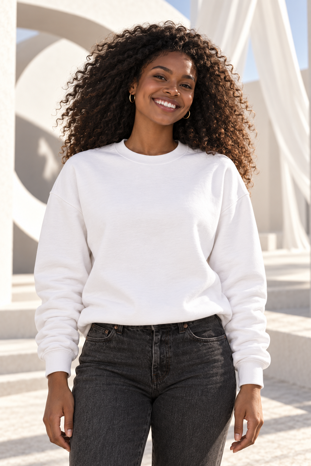 A smiling woman in a white Manifesting Circle sweatshirt
